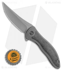 WE Knife Co. Mini Synergy Flipper Knife Ti/Marble CF (3" SW Trailing) 2011CF-A -We Knife Co. WE Knife Co. Mini Synergy Flipper Knife Ti Marble CF 3 SW Trailing 2011CF A BHQ 106953 LS Bottlecap